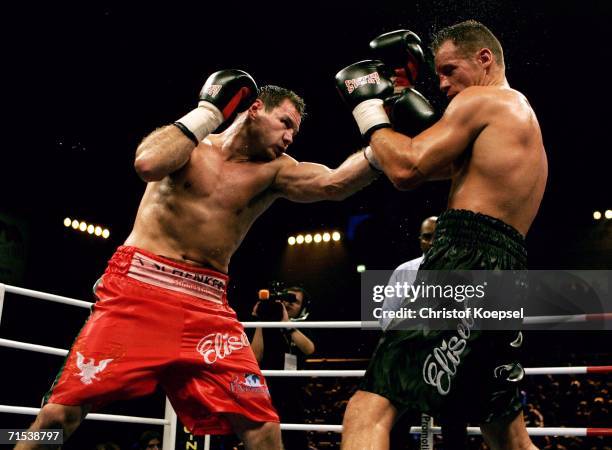 Zsolt Erdei of Hungary fights against Thomas Ulrich of Germany during the WBO Light Heavyweight Title fight at the Koenig-Pilsener Arena on July 29,...