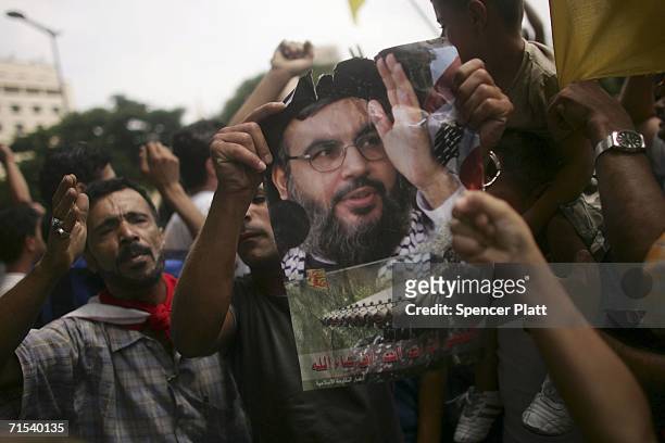 Demonstrator holds up a picture of Sheik Hassan Nasrallah, the leader of Hezbollah as thousands of Lebanese protest in front of the United Nations...