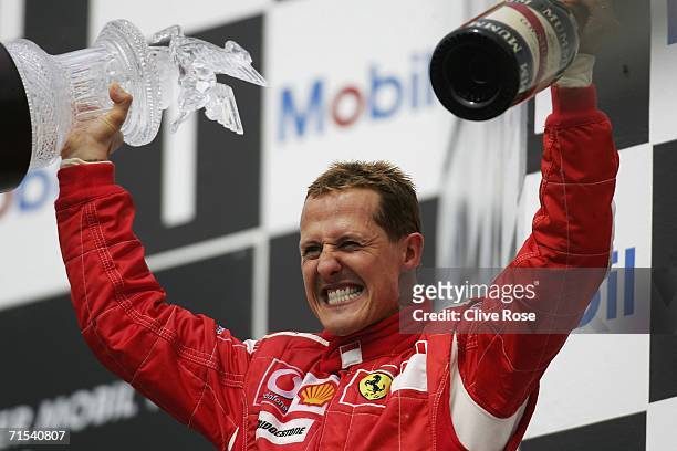 Michael Schumacher of Germany and Ferrari celebrates on the podium after winning the German Formula One Grand Prix at the Hockenheimring on July 30,...