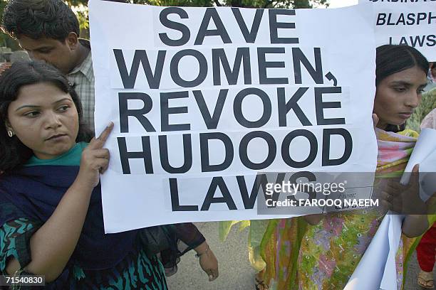 Pakistani women hold a placard during a demonstration against the Hudood law in Islamabad, 30 July 2006. The laws were introduced in 1979 by Islamist...