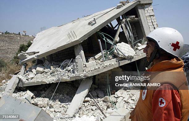 Lebanese Red Cross member inspects the cleaning process of the building destroyed by Israeli air raids that killed at least 52 civilians in the...