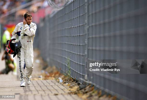 Jacques Villeneuve of Canada and BMW Sauber leaves the track after crashing out during the German Formula One Grand Prix at the Hockenheimring on...