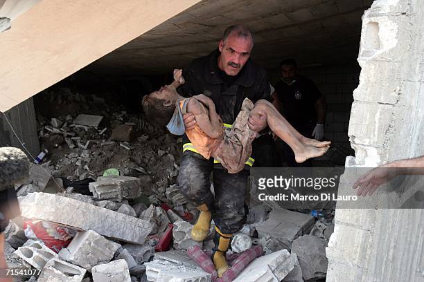 Rescue team member extracts the dead body of one of the victims of the Israeli air strike from the rubble of the building that was hit July 30, 2006...