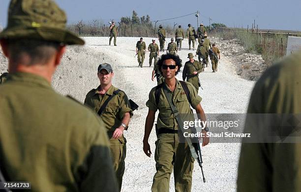 Israeli army reservists walk to a firing range after being called up under emergency orders July 30, 2006 at the Elyakim training base in northern...