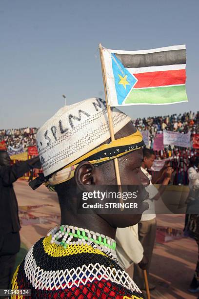 Sudanese wears the flag of People's Liberation Movement as Sudanese gather in Khartoum's twin city of Omdurman to pay homage to mark the first...