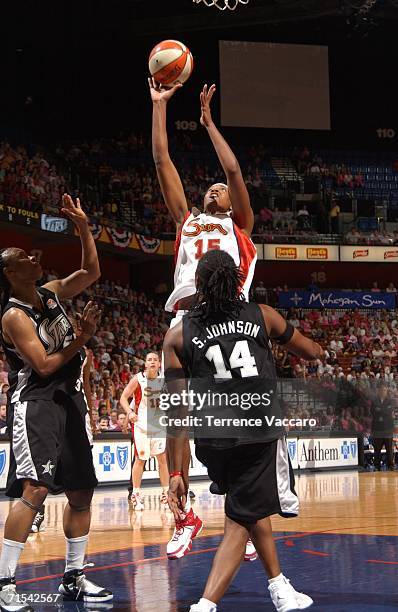 Asjha Jones of the Connecticut Sun goes to the basket against Shannon Johnson of the San Antonio Stars at Mohegan Sun Arena on July 30, 2006 in...