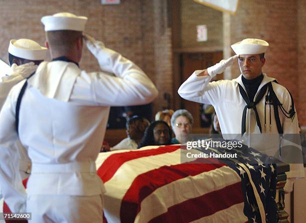 In this handout image released by the U.S. Navy, Commander, Navy Region Mid-Atlantic Honor Guard salute as they bring retired Master Chief...