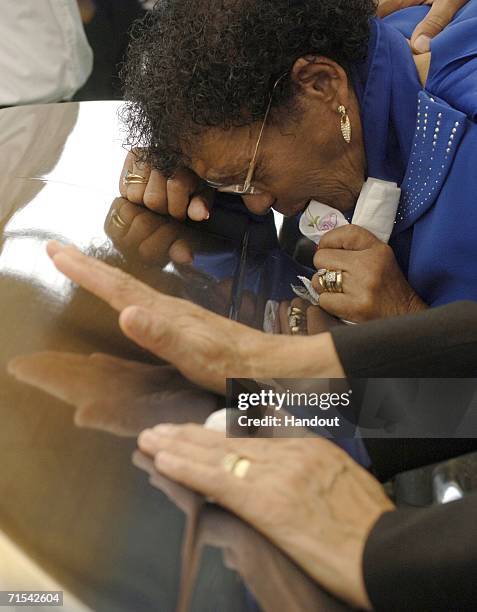 In this handout image released by the U.S. Navy, family and friends of Master Chief Boatswain's Mate Carl M. Brashear pay their final respects during...