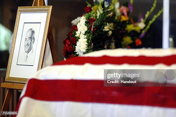 In this handout image released by the U.S. Navy, a portrait of Master Chief Boatswain's Mate Carl M. Brashear is displayed beside his casket during a...