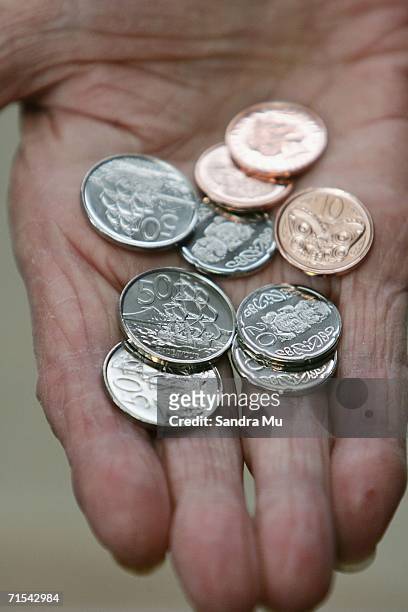 The new 10, 20 and 50 cent pieces which began circulation for the first time today, sit in the palm of a hand July 31, 2006 in Auckland, New Zealand....
