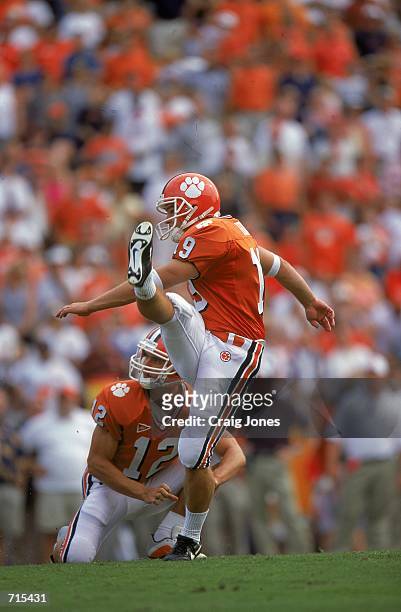 Aaron Hunt of the Clemson Tigers kicks the ball for a field goal while Jeff Scott holds the ball during the game against the Missouri Tigers at Frank...