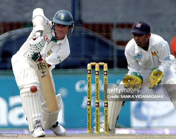 South African cricketer Nicky Boje is watched by Sri Lankan wicketkeeper Prasanna Jayawardene as he bats during the fifth and final day of the first...