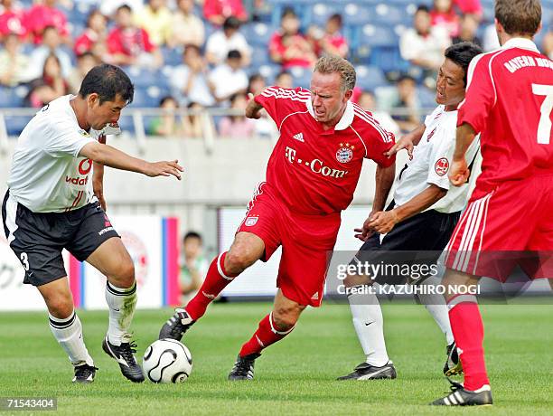 Legendary German football player Kar-Heinz Rummenigge , a member of the FC Bayern Munich All Stars, controls the ball against members of Japan's...