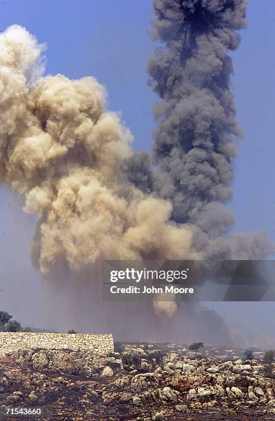 Smoke shoots into the sky after an Israeli airstrike in southern Lebanon on July 31, 2006 near the Israel Lebanon border. Israeli troops crossed into...