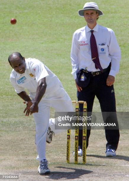 Sri Lankan cricketer Sanath Jayasuriya is watched by umpire Billy Bowden as he delivers a ball against South Africa during the final day of first...