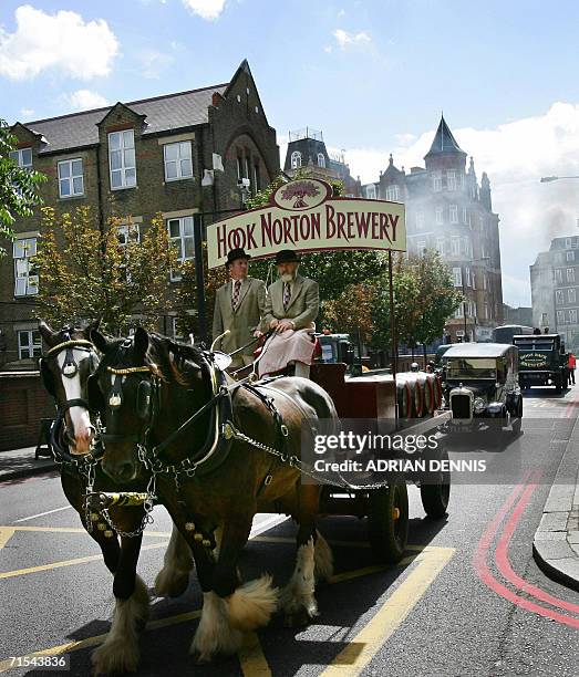 London, United Kingdom: A horse-drawn dray from Hook Norton Brewery is followed by vintage vehicles during a welcome parade of British brewers...