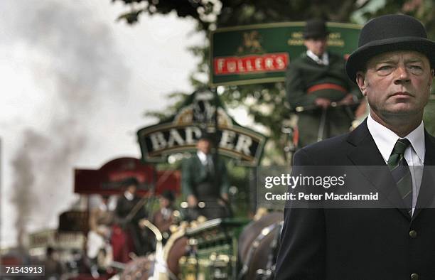 Groom in a bowler hat walks with traditional brewer's wagons before the start of the Great British Beer Festival on July 31, 2006 in London. The...