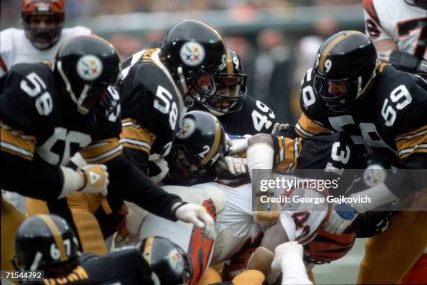 Linebackers Jack Ham, Jack Lambert and Robin Cole and defensive backs Donnie Shell, J.T. Thomas and Dwayne Woodruff of the Pittsburgh Steelers tackle...