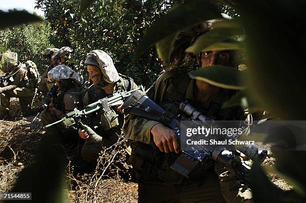 Israeli soldiers take positions along the Israeli Lebanese border prior to entering into Lebanon, July 20, 2006 in Israel. Lebanese Prime Minister...