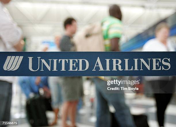 Travelers are seen in line beyond stanchion strapping July 31, 2006 in the United Airlines terminal at O'Hare International Airport in Chicago,...