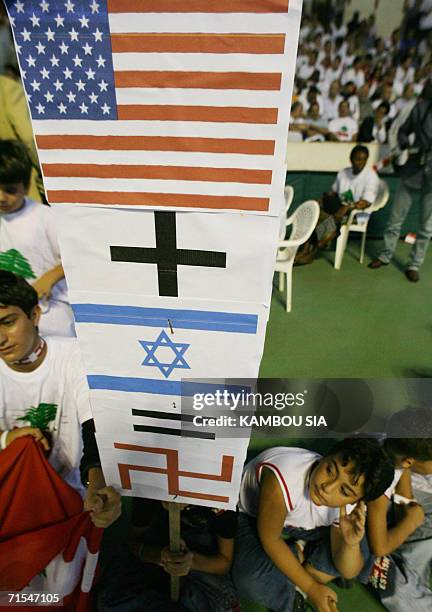 Lebanese expatriots hold a placard 31 July 2006 in Abidjan during a demonstration against the Israeli bombardments of Lebanon. The United Nations...