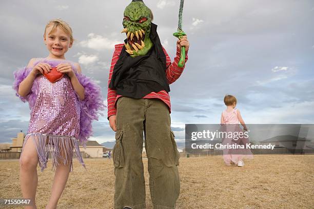 young boy dressed up as a monster and young girl dressed up in a 1920s flapper costume - 1920s flapper girls stock pictures, royalty-free photos & images