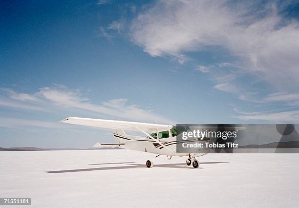 propeller airplane on salt flat - propeller airplane stock pictures, royalty-free photos & images