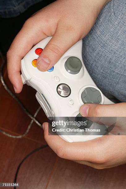 boy holding white video game control - control pants foto e immagini stock