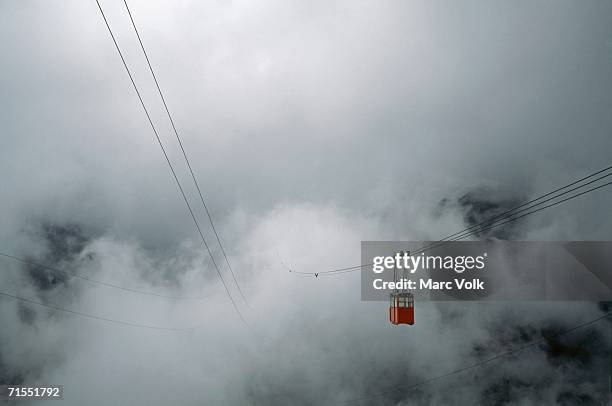 overhead cable car traveling into mist, m?rida, venezuela - merida venezuela stock pictures, royalty-free photos & images
