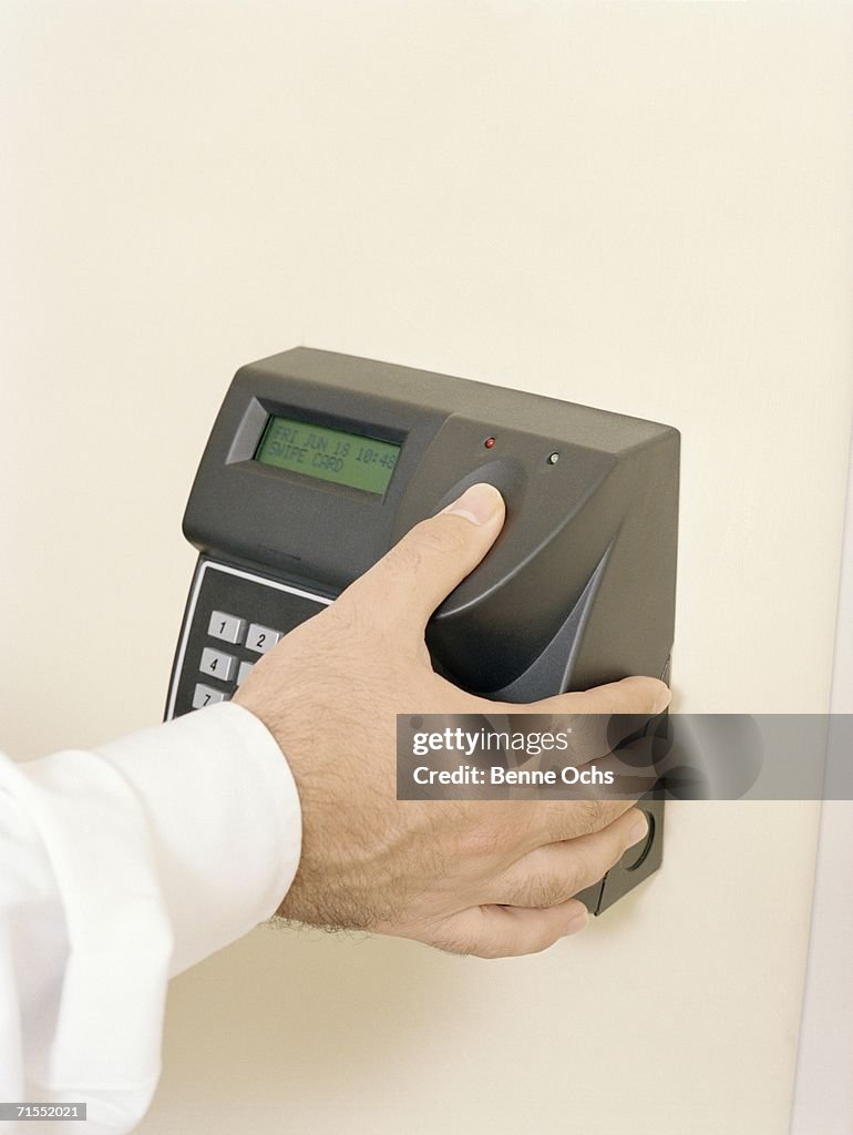Businessman using biometric identification system