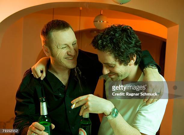 two men drinking beer at a bar - bar man t shirt ストックフォトと画像