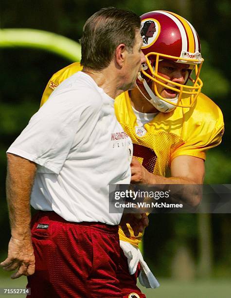 Quarterback Mark Brunell jokes with Assistant Head Coach Offense Joe Bugel as the Washington Redskins take the field for the first day of training...