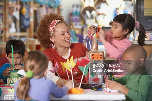 african american female art teacher with young students - preschool classroom stock pictures, royalty-free photos & images