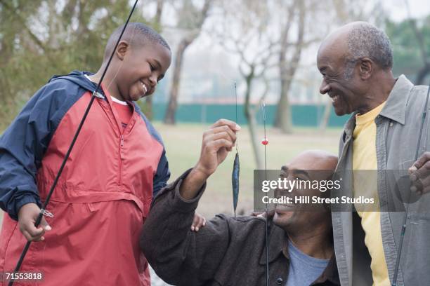 african american family with fishing poles - funny hobbies stock pictures, royalty-free photos & images