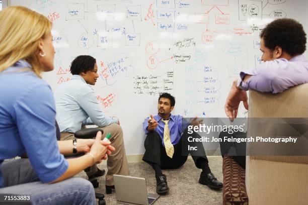 businesspeople having a meeting in front of a whiteboard wall - three quarter length stock pictures, royalty-free photos & images