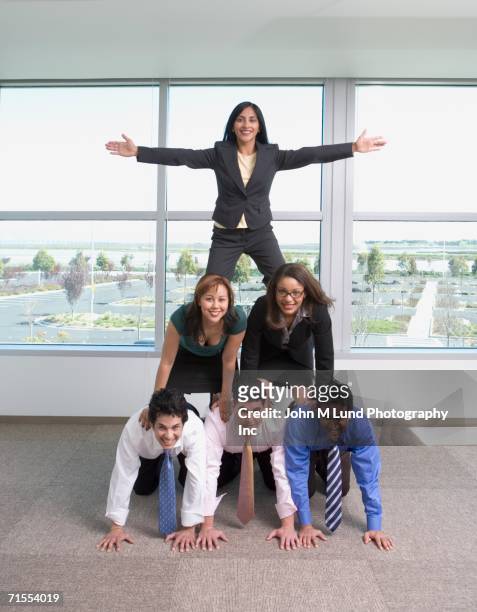 group of coworkers in pyramid trust exercise - human pyramid fotografías e imágenes de stock