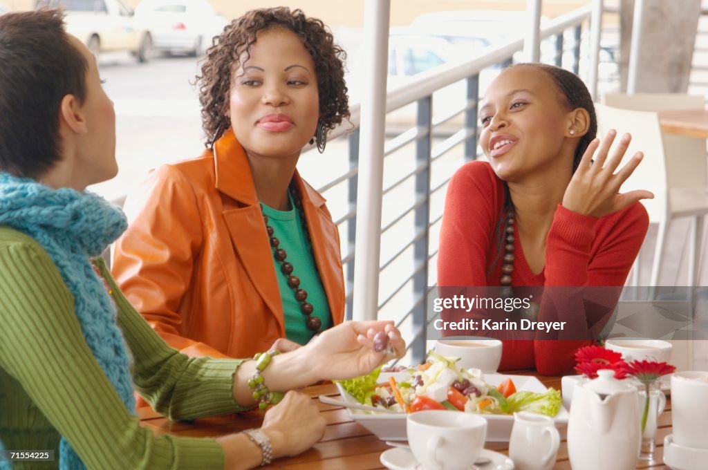 Three women eating and talking