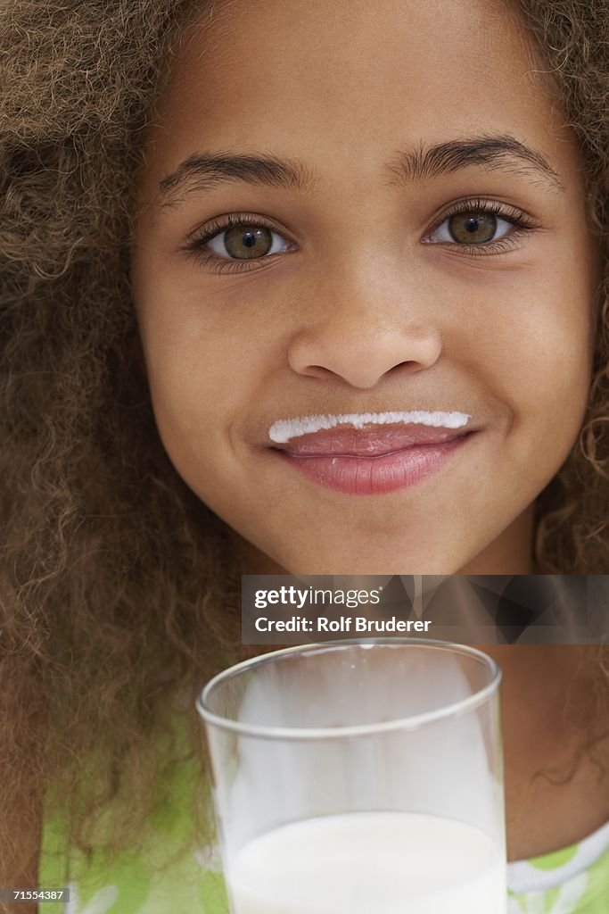 Close up of African American girl with milk mustache