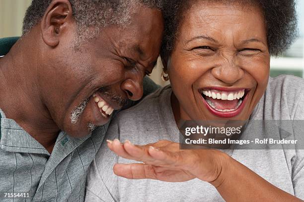 close up of senior african american couple laughing - männer portrait gesicht close up stock-fotos und bilder