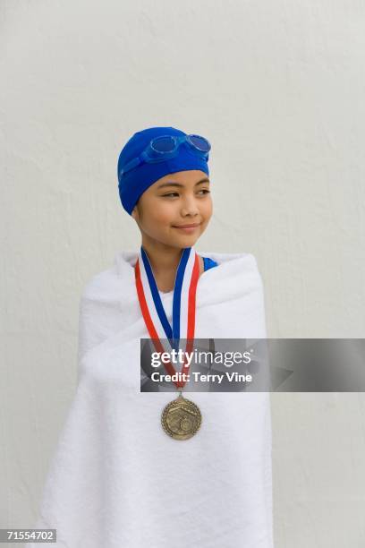 hispanic girl wrapped in towel with swimming metal - kids swim caps stock pictures, royalty-free photos & images