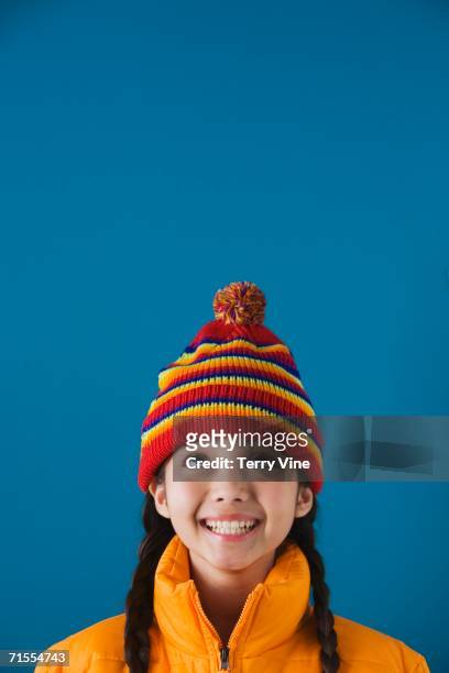 studio shot of young girl wearing hat and jacket - girl rising stock-fotos und bilder