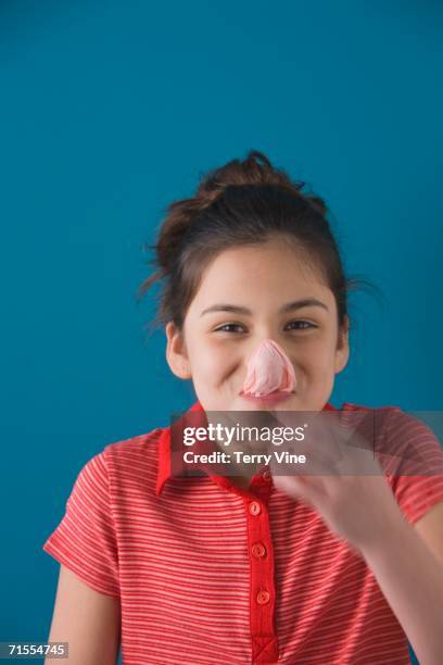 studio shot of young hispanic girl with popped bubble gum bubble - bubble gum kid stock pictures, royalty-free photos & images