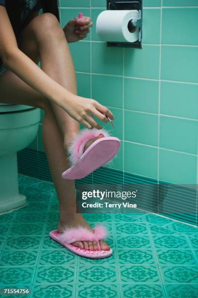 girl painting toenails in bathroom - childrens closet stockfoto's en -beelden