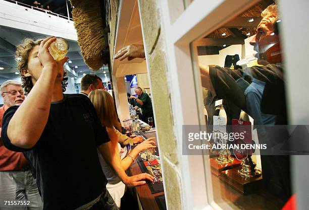 London, United Kingdom: A drinker sinks a pint at The Badger Ales bar during the opening day of The Great British Beer Festival in Earls Court...