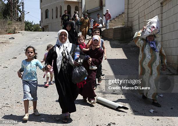 Lebanese civilians attempt to flee after being trapped in poor conditions as a result of the Israeli bombing campaign on August 1, 2006 in the...