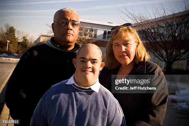 Eli Lewis a high school freshman, poses with his father Howard Lewis and mother Mary Ann Dawedeit outside of Walter Johnson High School December 18,...