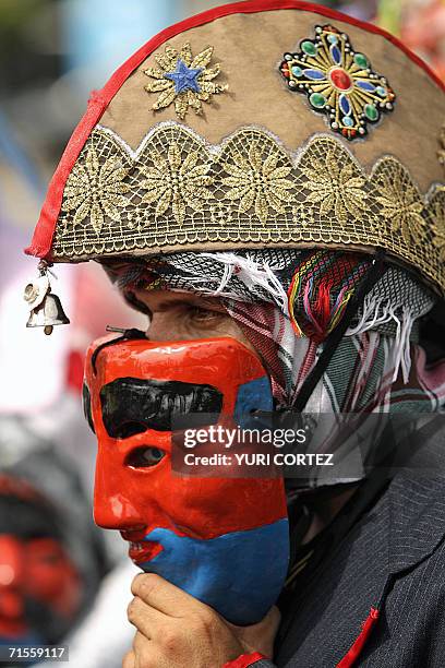 San Salvador, EL SALVADOR: Un hombre vestido con un traje tipico usa una mascara mientras participa en la tradicional "Danza de los Historiantes" el...