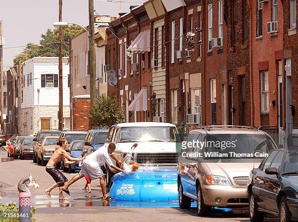 Woman is thrown into a pool during a heat wave that is gripping the northeast August 1, 2006 in Philadelphia, Pennsylvania. Record breaking...