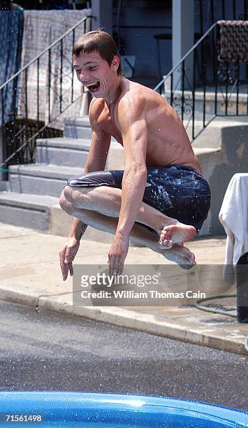 Steven Tonkin dives into a pool during a heat wave gripping the northeast August 1, 2006 in Philadelphia, Pennsylvania. Record breaking temperatures...
