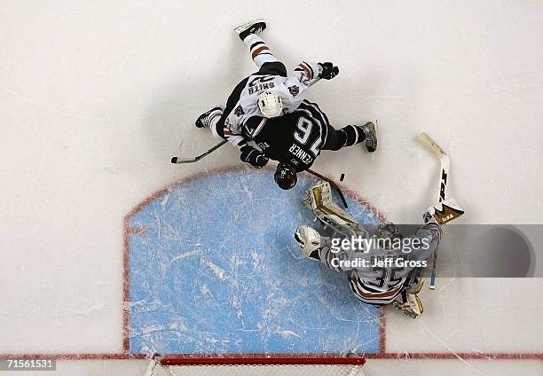 Goaltender Dwayne Roloson of the Edmonton Oilers defends his net against the scoring attempt by Dustin Penner of the Mighty Ducks of Anaheim during...